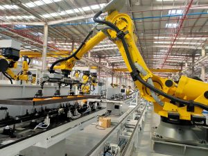 Industrial robot arm using an electro-permanent magnetic gripper to automate steel material handling in a production line